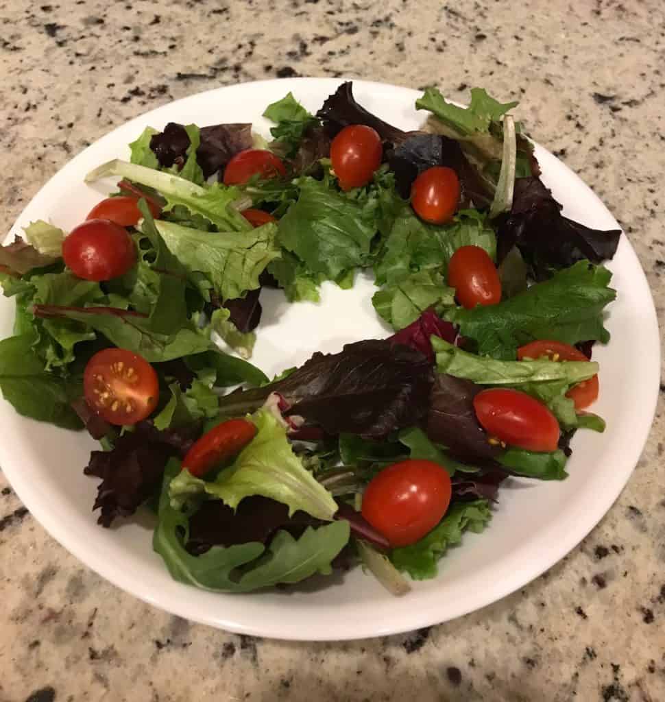 Ring of mixed salad greens and cherry tomato halves