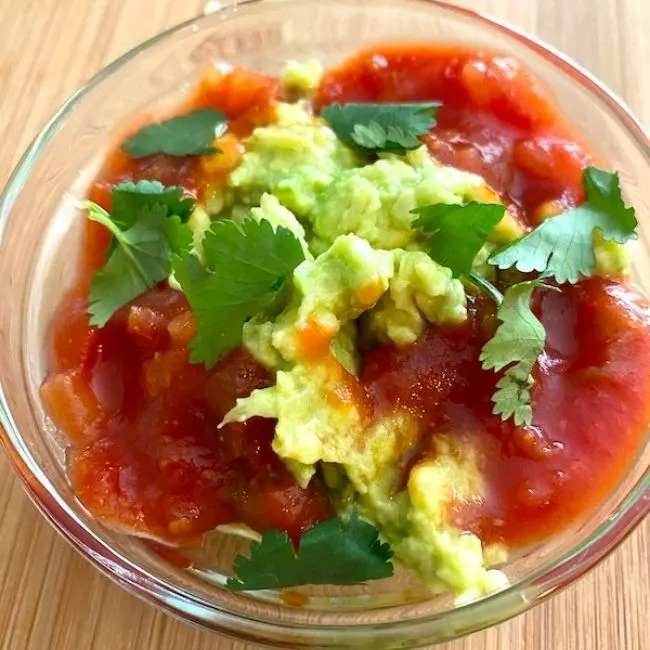 bowl of guacamole with salsa