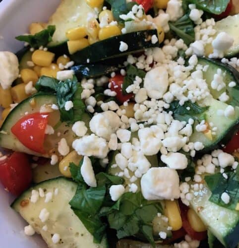 A tomato cucumber corn salad is a delicious side dish for any meal.
