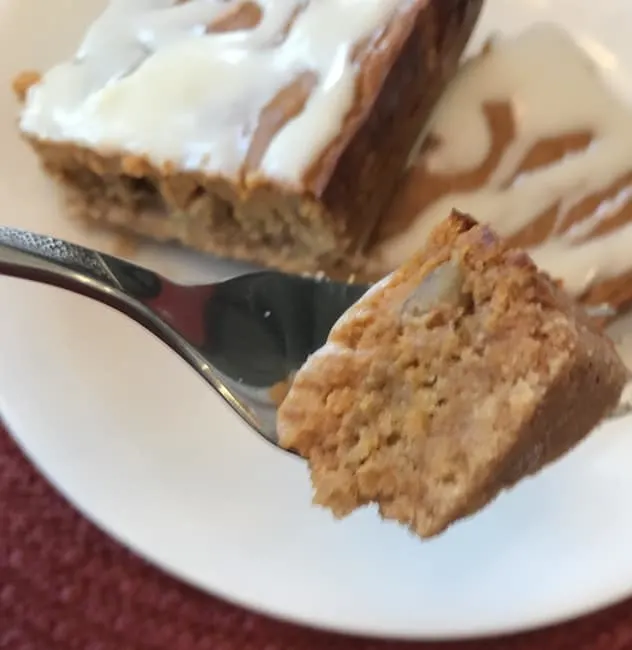 A fork holding a bite of pumpkin bar