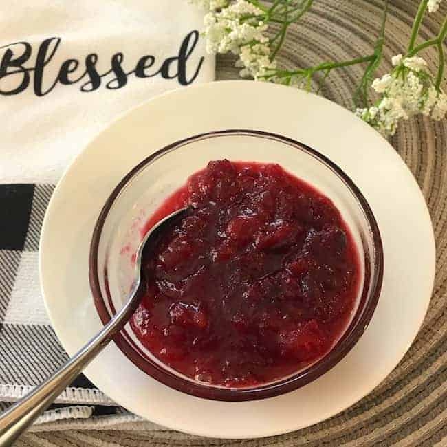 Cranberry sauce in a bowl with a spoon