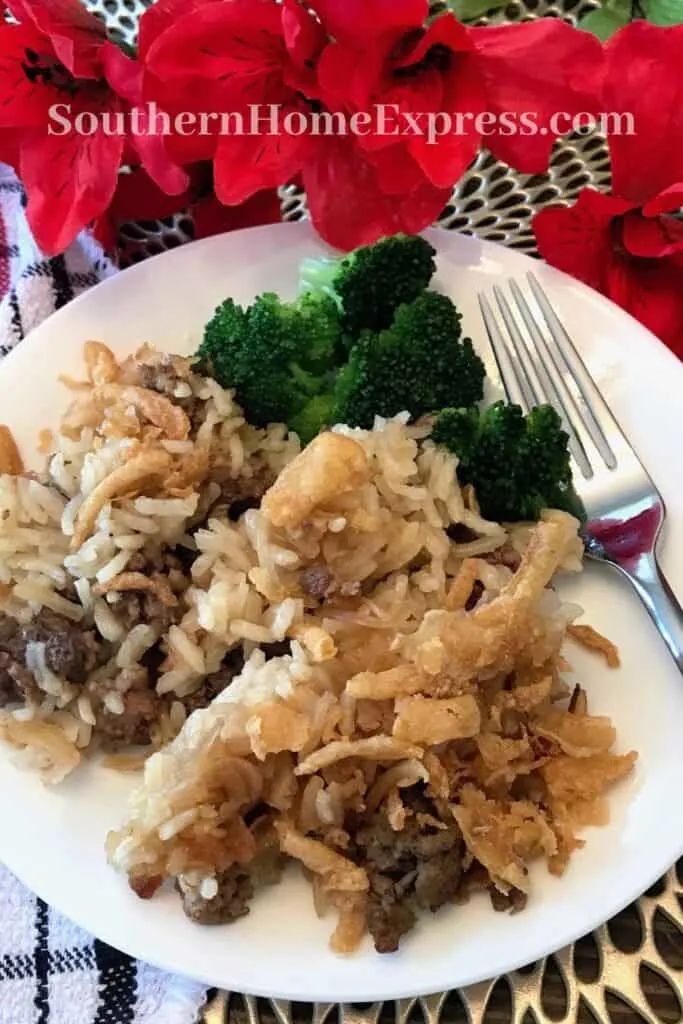 beef and rice casserole on a plate with steamed broccoli