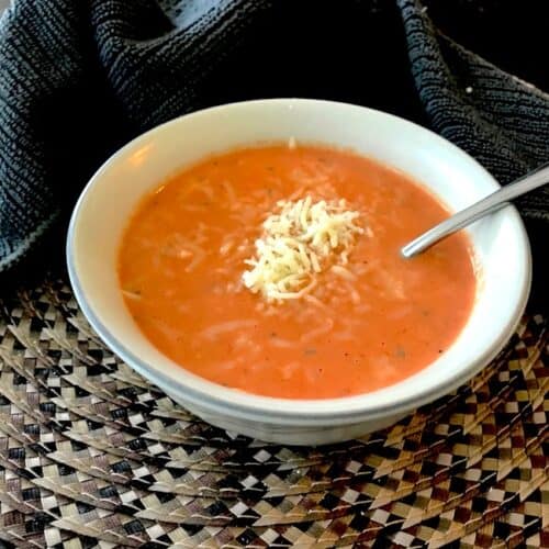 Bowl of cream of tomato soup with cheese on top