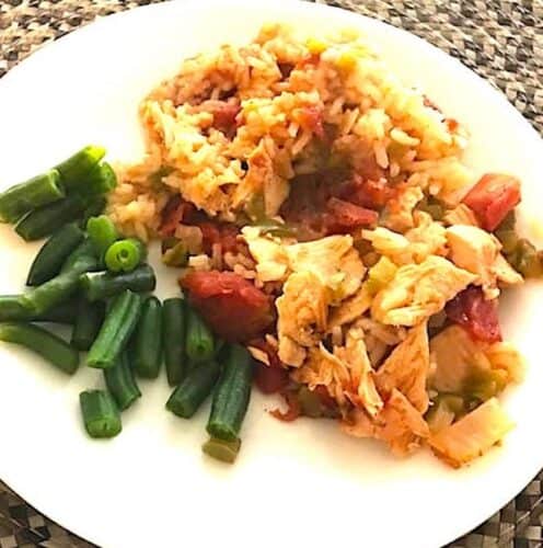 Chicken creole and green beans on a plate