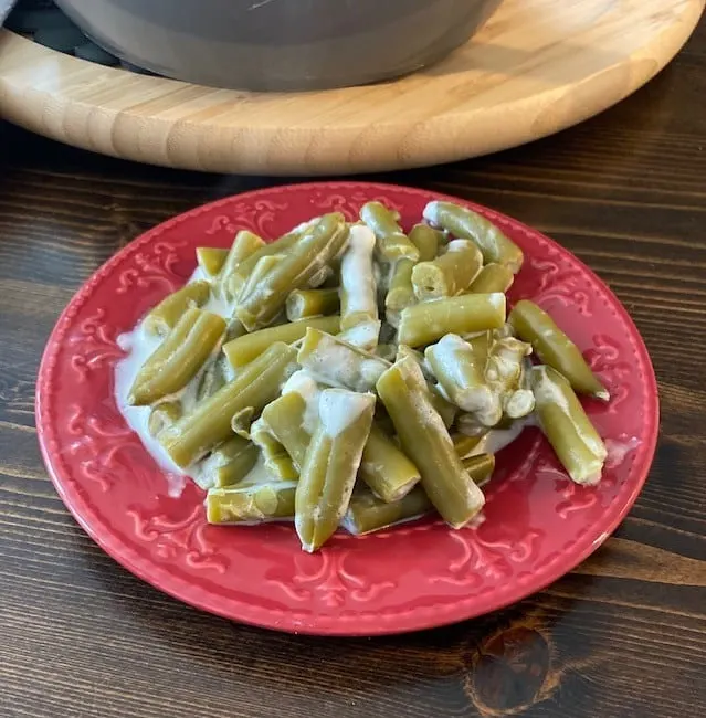 Serving of cheesy green beans on a plate