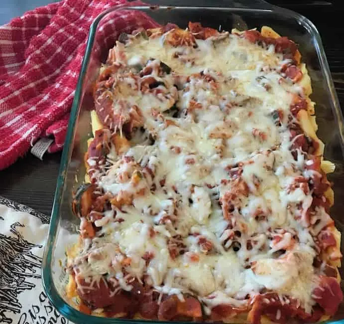 Casserole in a pan beside a red dish towel