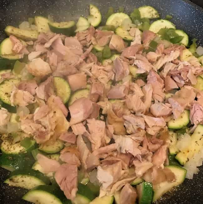 Chicken, zucchini, and onions in a pan