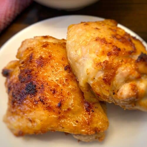 2 air fryer chicken thighs on a plate