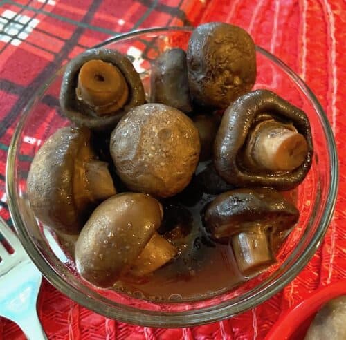 Bowl of marinated mushrooms on a red towel