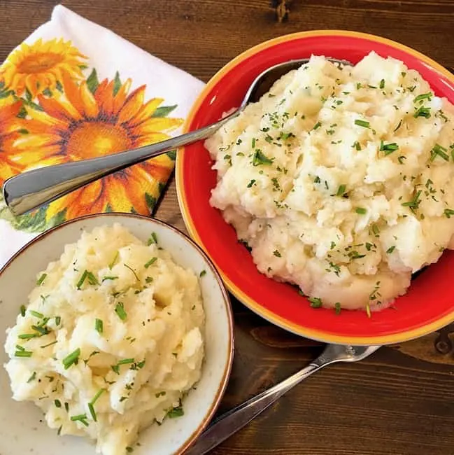 2 bowls of buttermilk garlic mashed potatoes with chives