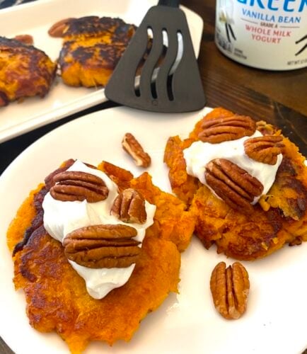 sweet potato patties with yogurt and pecans on a plate