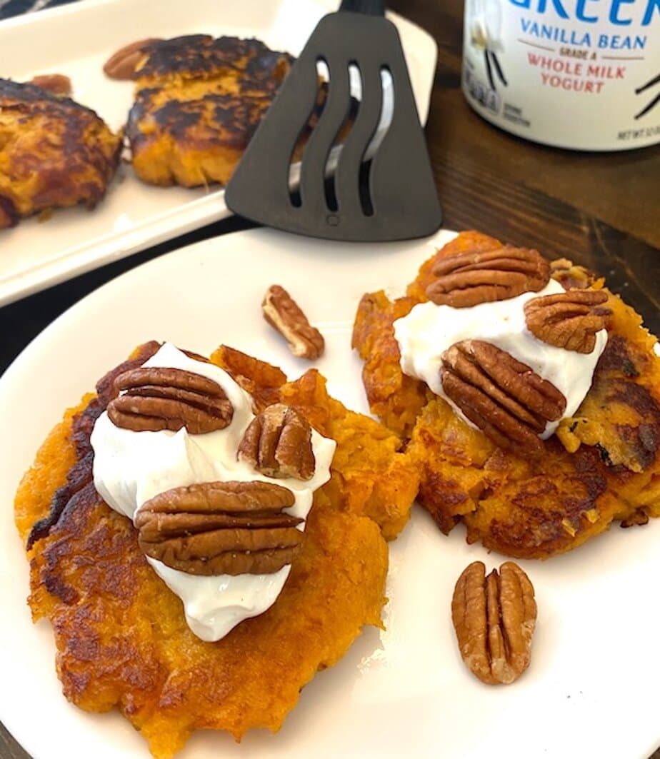 sweet potato patties with yogurt and pecans on a plate
