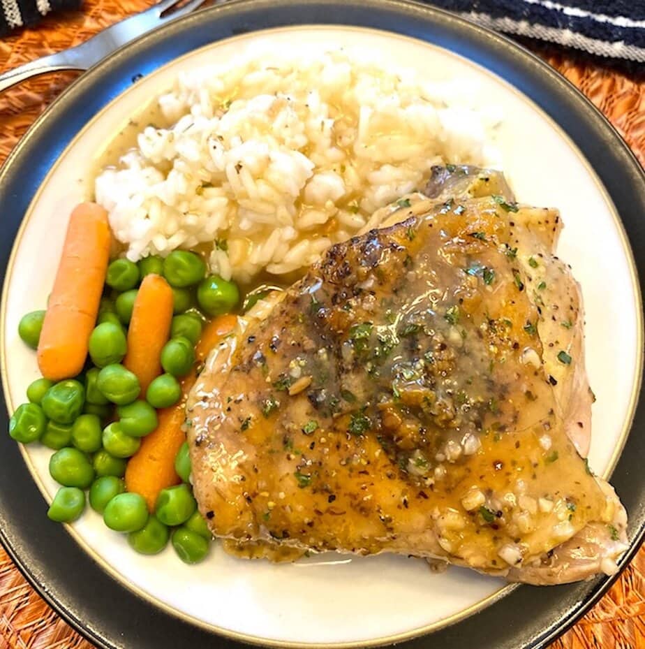plate of lemon pepper chicken, rice, and mixed vegetables