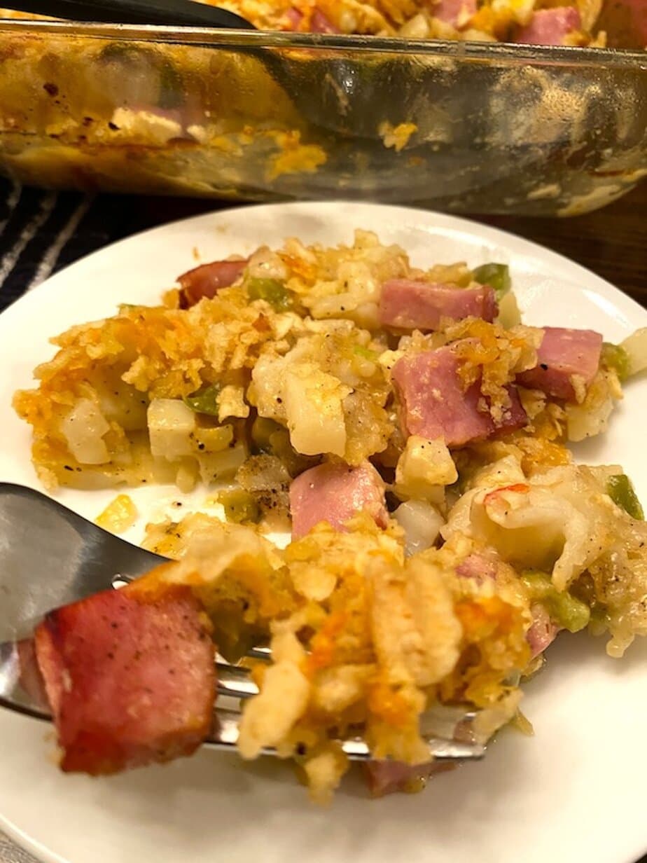 ham and potato casserole on a plate, on a fork, and in a casserole dish