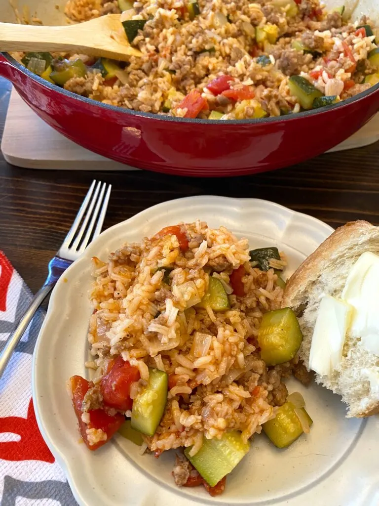 pan and plate of pork sausage and rice skillet dinner