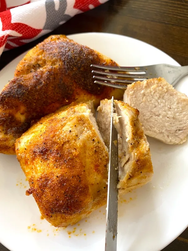 slicing chicken breast on a plate