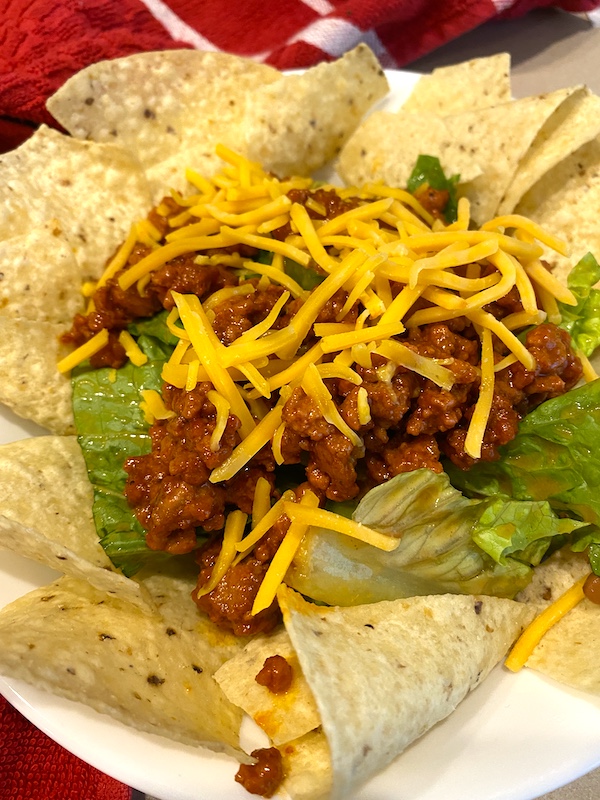 Catalina taco salad over chips and topped with shredded cheddar cheese