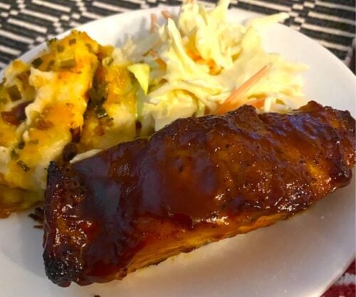 plate of bbq ribs with coleslaw and potatoes