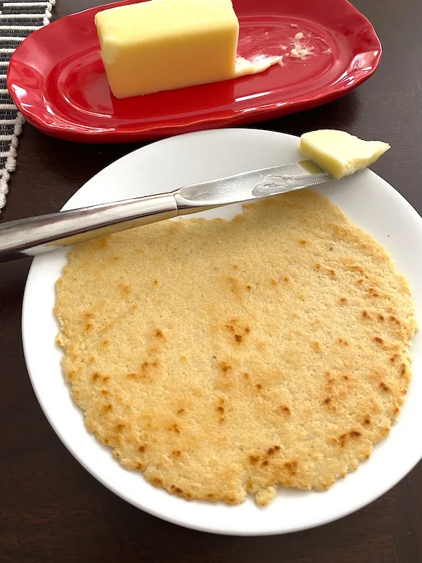 almond flour tortilla on a plate with a knife and butter