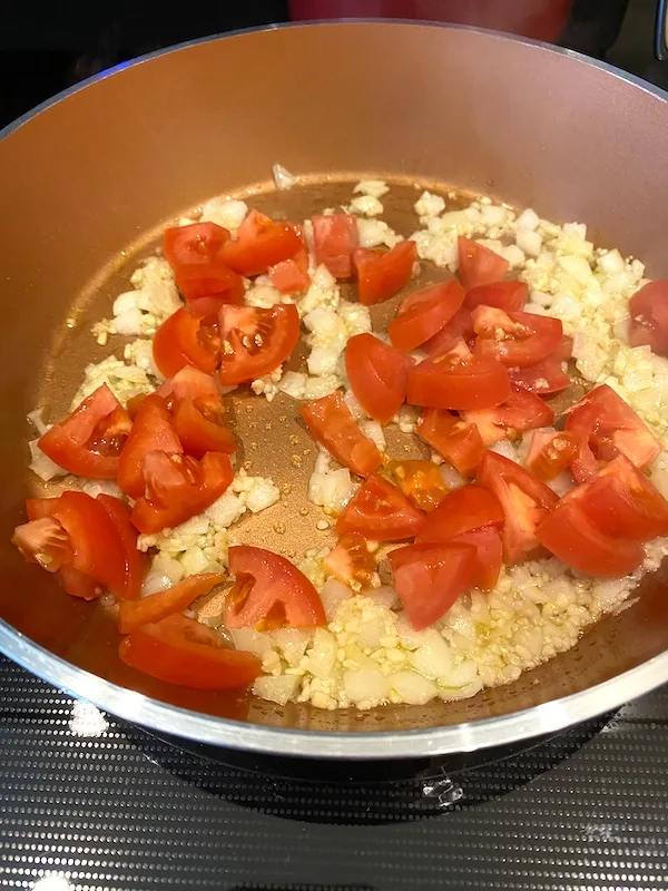 diced tomatoes added to the skillet