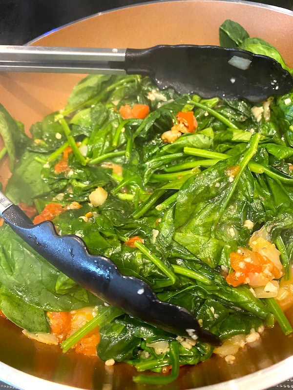 spinach in the pan as it cooks and wilts down