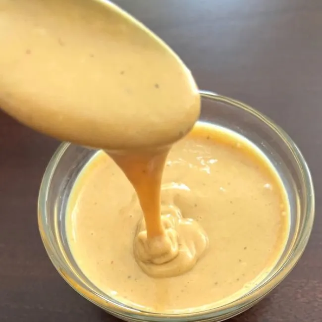 scooping copycat chick fil a sauce with a spoon