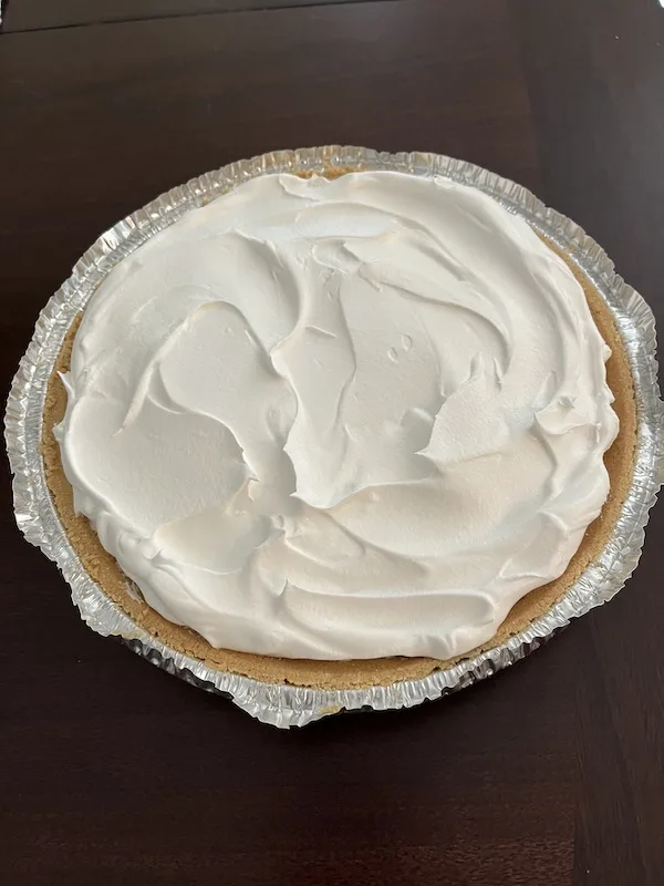 whipped topping spread over the pie