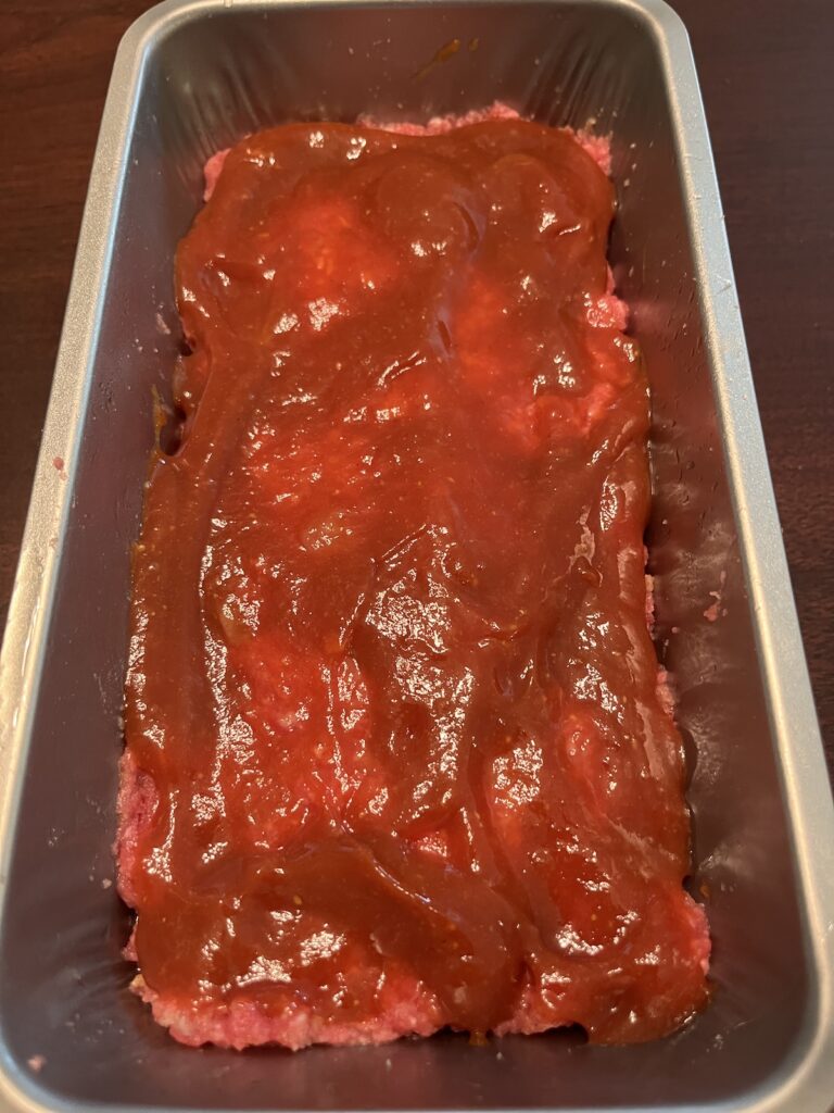 uncooked meatloaf with topping