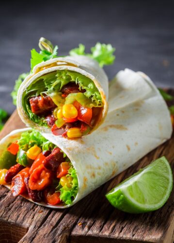 2 burritos on a cutting board