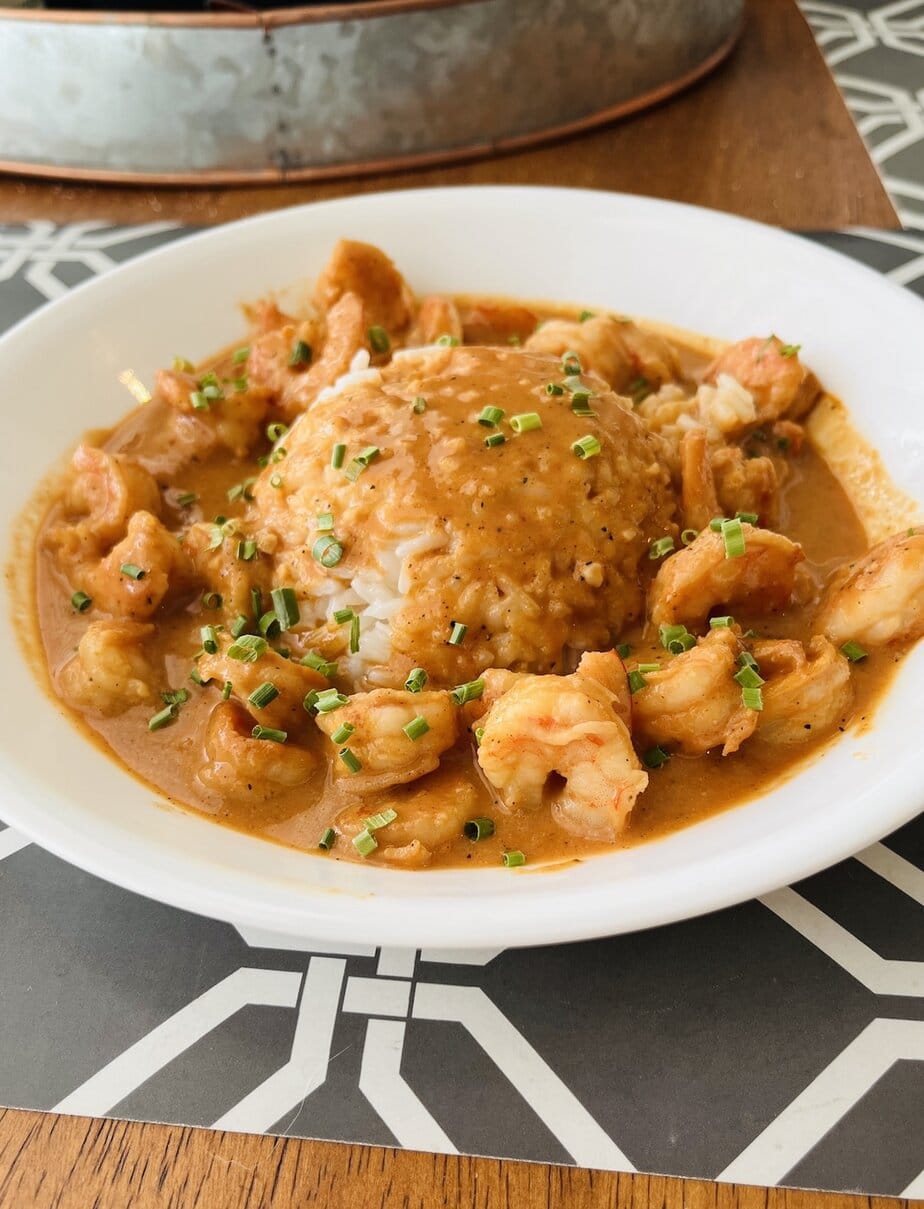 bowl of shrimp and rice covered in creamy cajun shrimp sauce