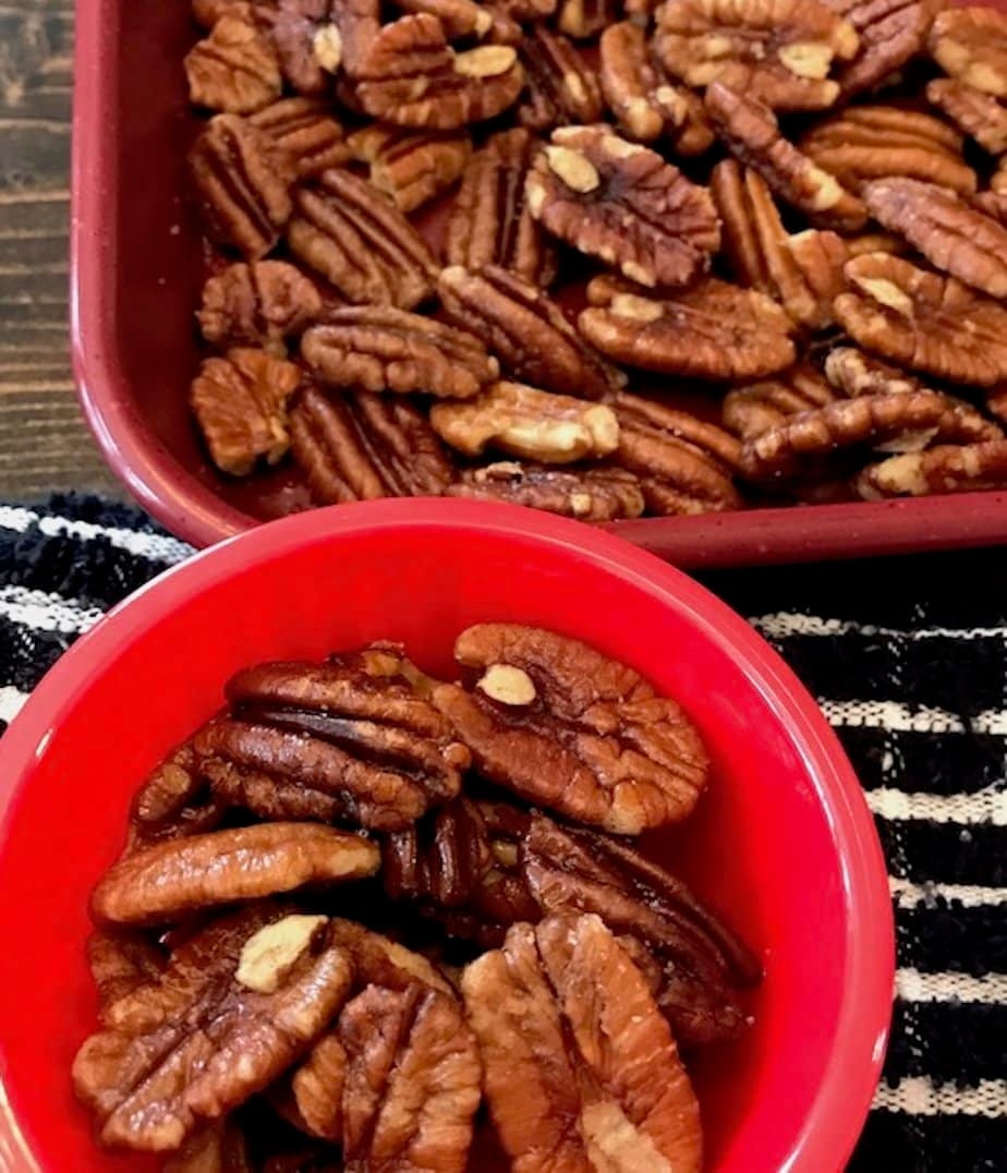 pan and bowl of oven-roasted pecans