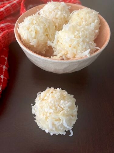coconut balls in a bowl and on the table