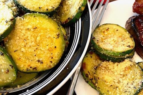 bowl and plate of garlic zucchini parmesan