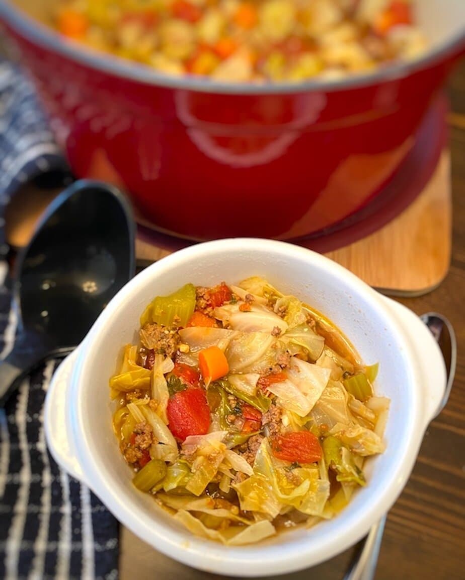 Bowl and pot of beef and cabbage soup