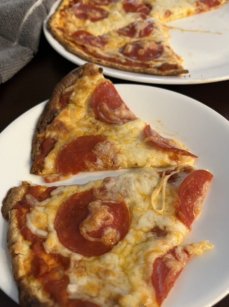 sliced pepperoni pizza on a couple of plates