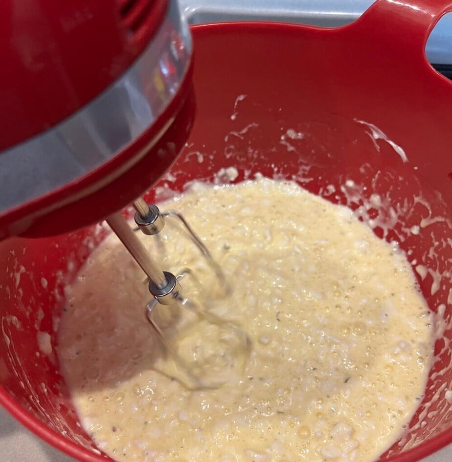 mixing low carb pizza crust ingredients with a hand mixer