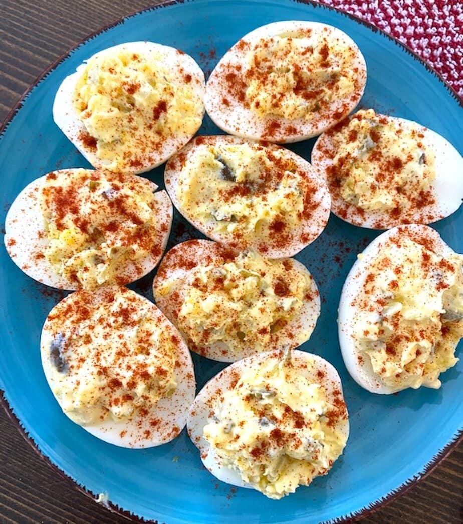 plate of deviled eggs sprinkled with paprika