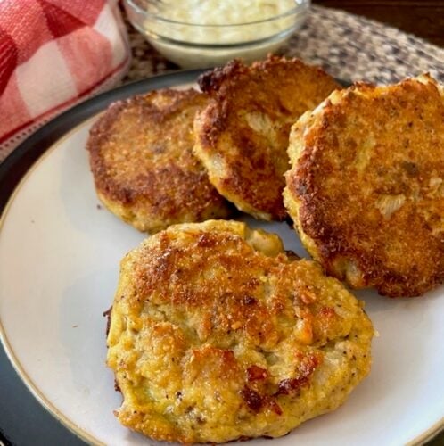 plate of salmon patties and bowl of tartar sauce
