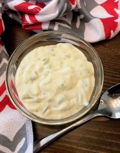 bowl of homemade tartar sauce beside a spoon
