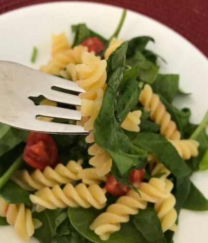 zesty rotini pasta salad on a plate with a fork