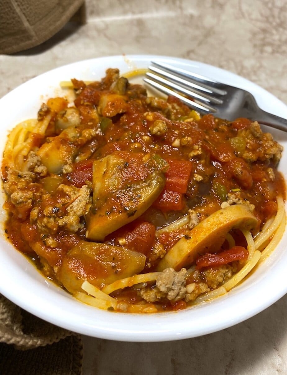 bowl of improved jarred spaghetti sauce over pasta