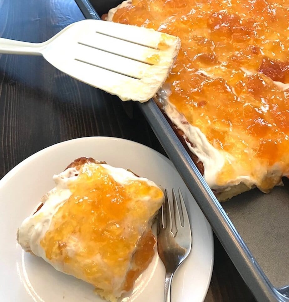 pan and plate of 2-ingredient peach cake with a spatula