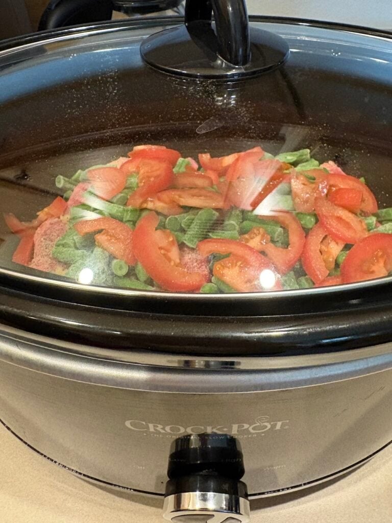 lid on Crock Pot full of chuck steak and vegetables