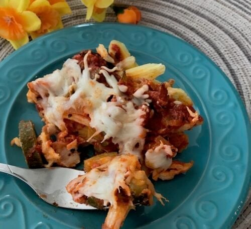 fork of Italian chicken zucchini casserole on a teal plate