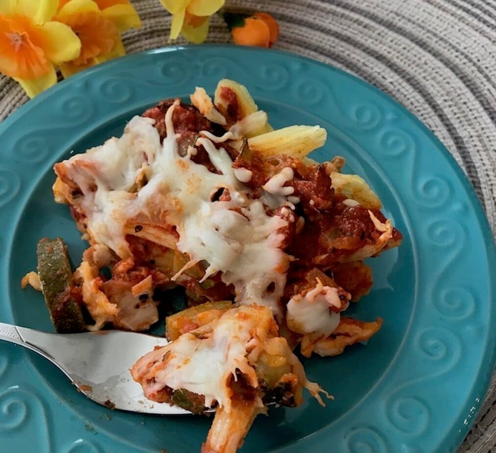 fork of Italian chicken zucchini casserole on a teal plate