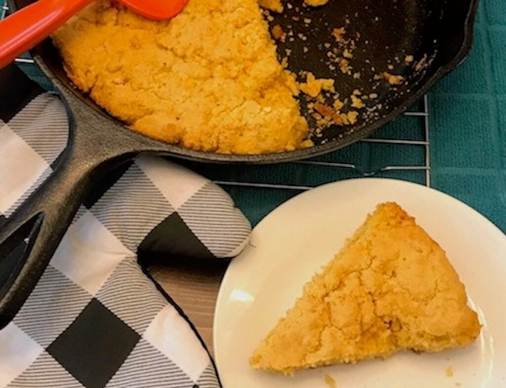 southern style cornbread in a pan and a slice of it on a plate
