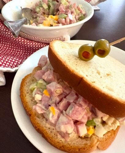 ham salad sandwich on a plate with olives