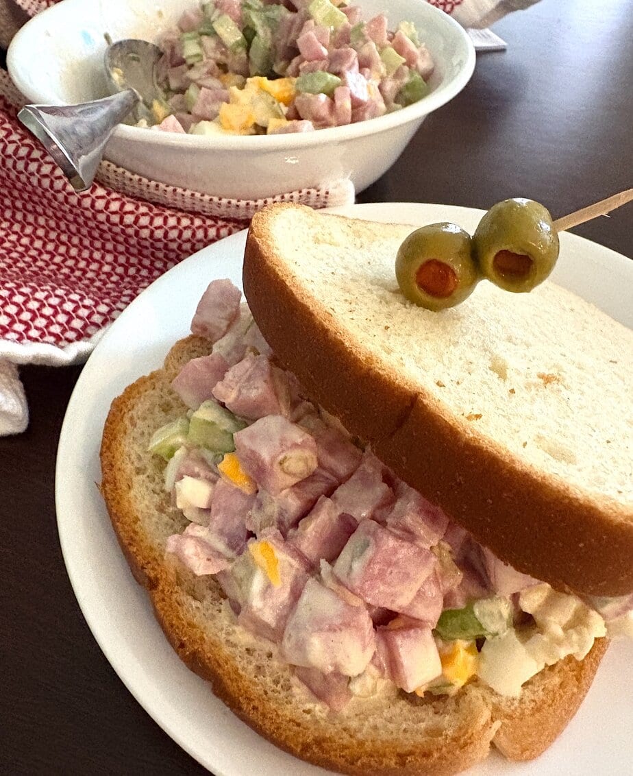 ham salad sandwich on a plate with olives
