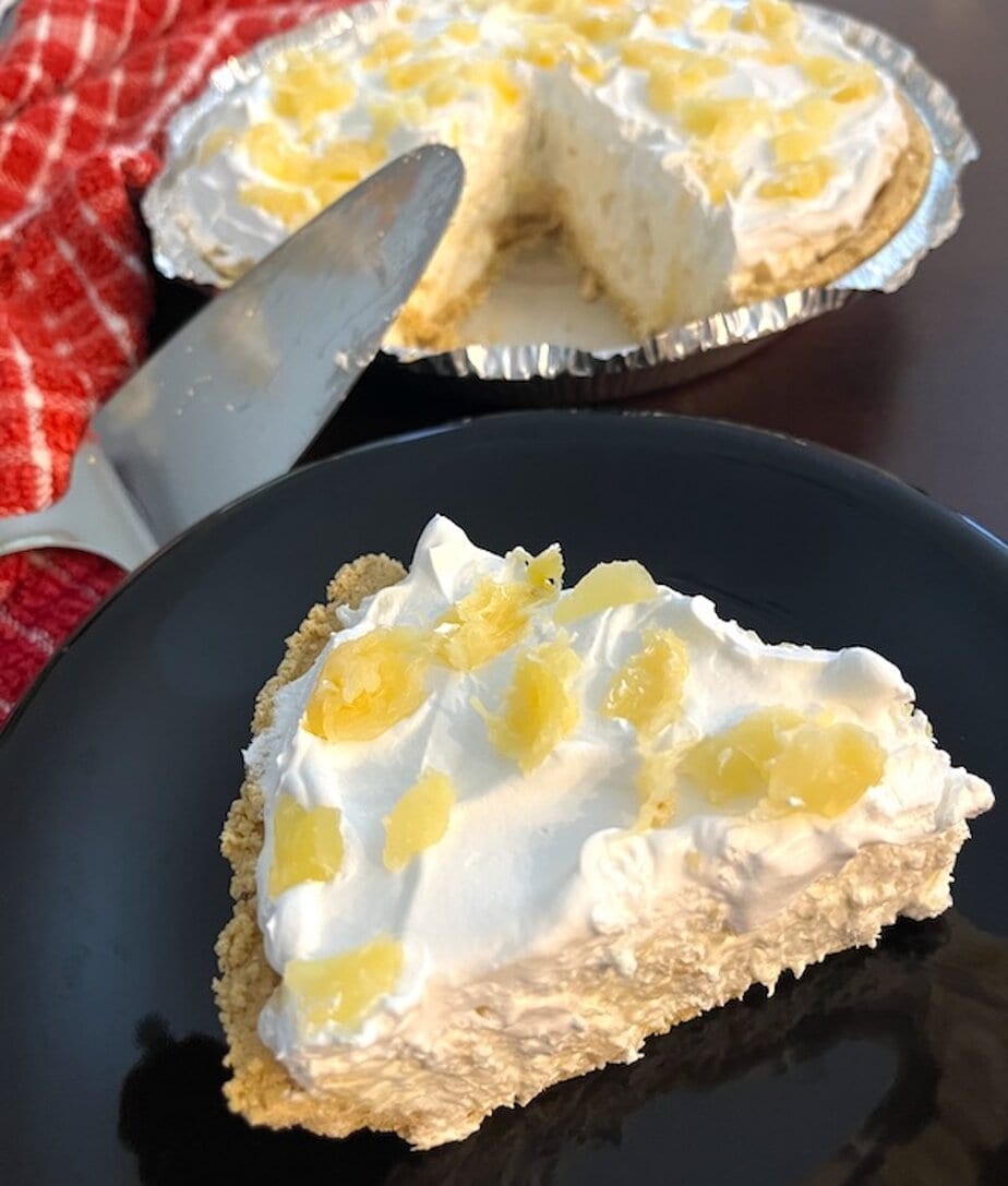 slice of pineapple pie in front of pan of pineapple pie