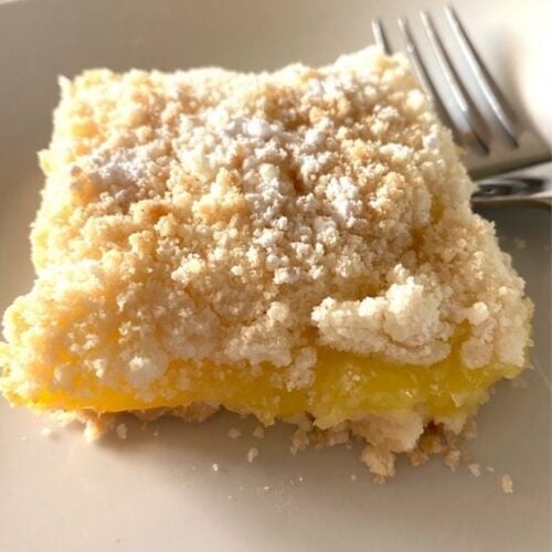 lemon bar on a plate with a fork